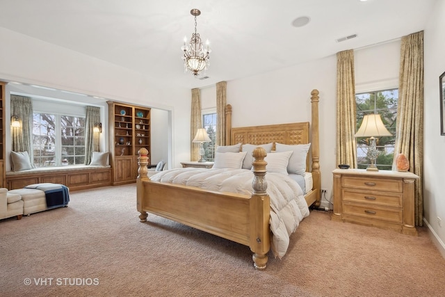 bedroom with light carpet, visible vents, and a notable chandelier