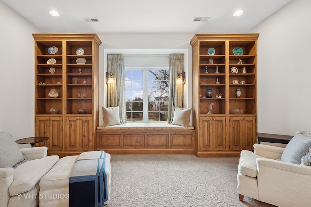 living area with light carpet, visible vents, and recessed lighting