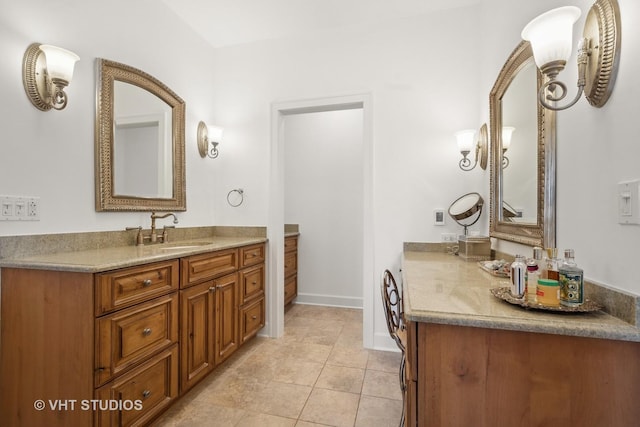 bathroom featuring vanity, baseboards, and tile patterned floors