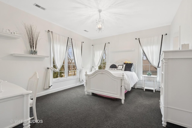 bedroom featuring an inviting chandelier, baseboards, visible vents, and dark carpet