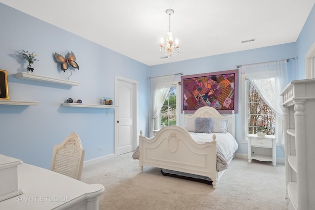 bedroom featuring carpet, visible vents, baseboards, and an inviting chandelier