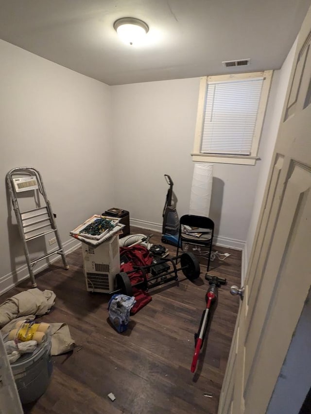 miscellaneous room featuring visible vents, baseboards, and wood finished floors