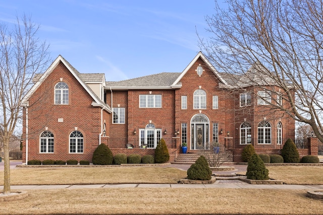 view of front of property with brick siding and a front yard