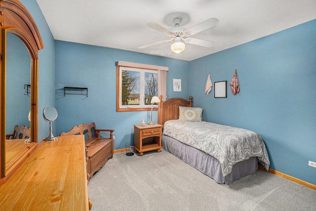 carpeted bedroom featuring ceiling fan and baseboards