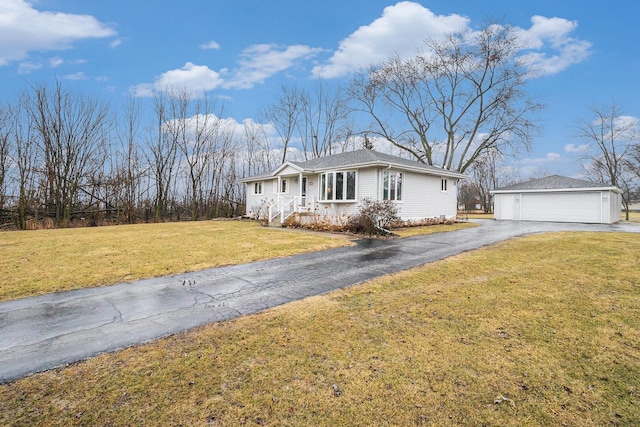 single story home featuring an outbuilding, a garage, covered porch, and a front lawn