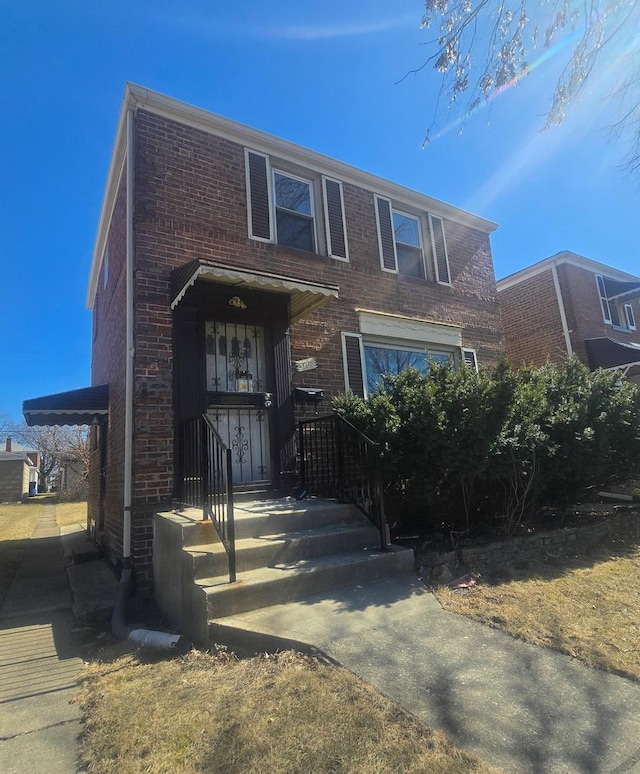 view of front of home featuring brick siding