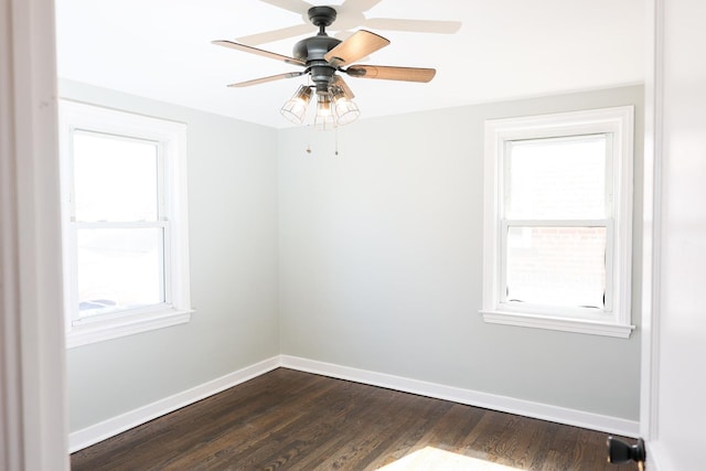 unfurnished room featuring a ceiling fan, baseboards, and dark wood-style flooring