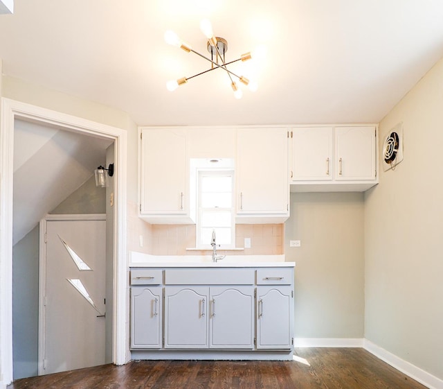 3707 S 59th Ct, Cicero, IL 60804 - kitchen with white cabinets, baseboards, tasteful backsplash, and a chandelier