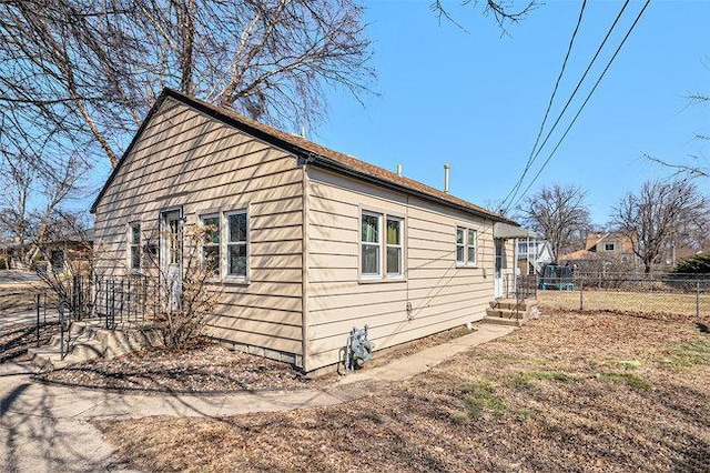 view of home's exterior featuring fence