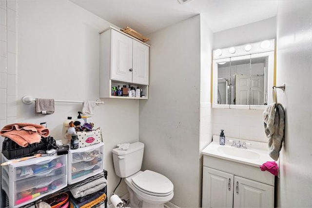 bathroom featuring visible vents, toilet, and vanity