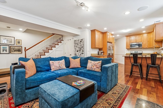 living room featuring recessed lighting, wood finished floors, stairs, and ornamental molding