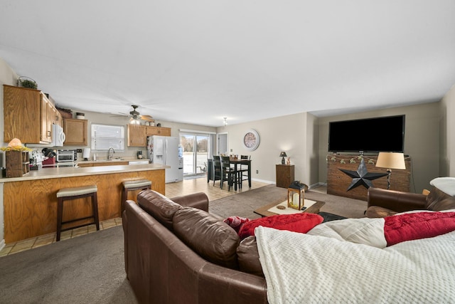 606 Effie Dr, Earlville, IL 60518 - living area with light carpet, ceiling fan, and baseboards