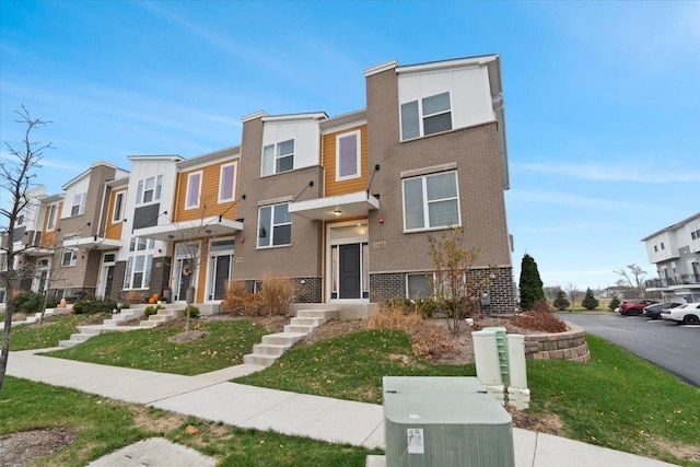 multi unit property featuring a residential view and brick siding