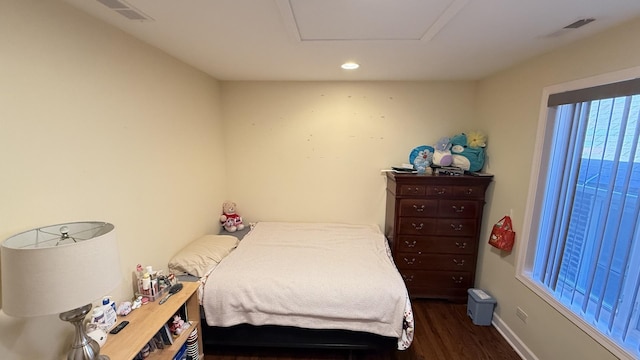 bedroom featuring visible vents, recessed lighting, baseboards, attic access, and dark wood-style flooring