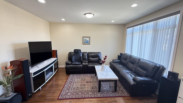 living area with recessed lighting and dark wood-style flooring