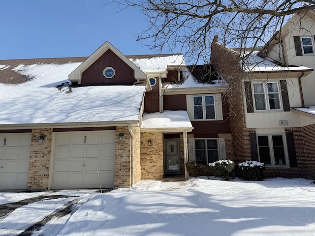 view of property with a garage and brick siding