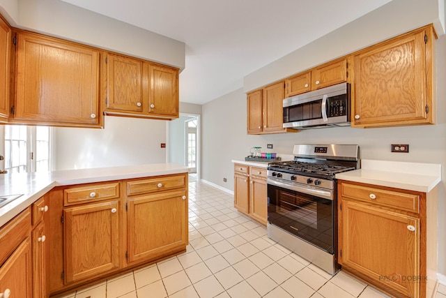 122 Kilchurn Ln, Inverness, IL 60067 - kitchen with stainless steel appliances, light countertops, light tile patterned floors, and a peninsula