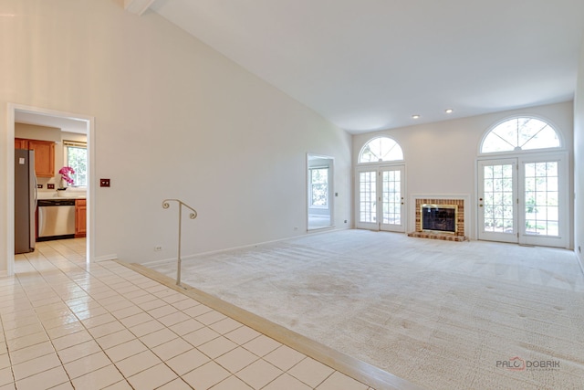 122 Kilchurn Ln, Inverness, IL 60067 - unfurnished living room with high vaulted ceiling, light colored carpet, plenty of natural light, light tile patterned floors, and baseboards