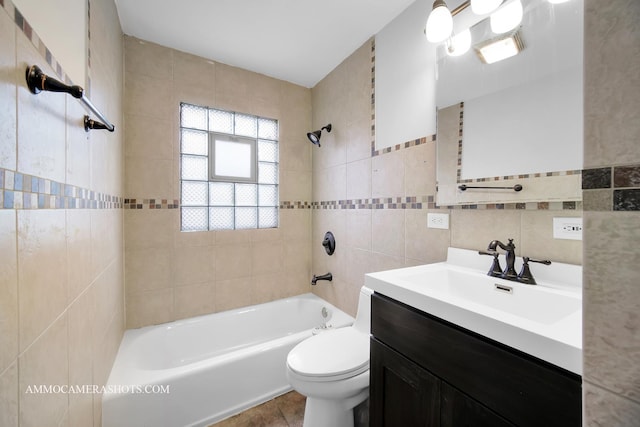 full bathroom featuring  shower combination, tile walls, toilet, and vanity