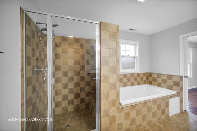 full bathroom featuring a stall shower, visible vents, and a tub with jets