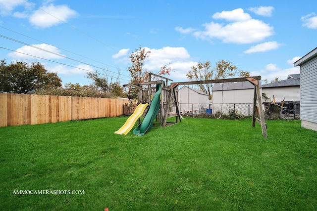 view of playground featuring a fenced backyard and a lawn