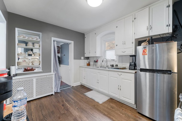 kitchen featuring white cabinetry, freestanding refrigerator, dark wood-type flooring, and light countertops