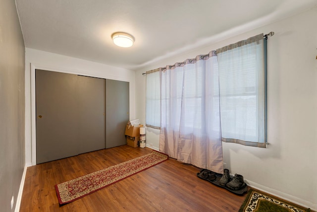 unfurnished bedroom with a closet and wood finished floors