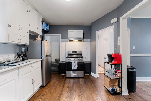 kitchen with white cabinetry, light countertops, dark wood-style flooring, and appliances with stainless steel finishes