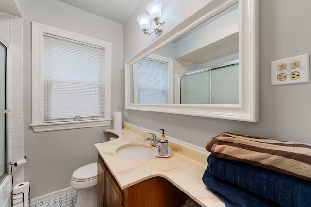 full bathroom with vanity, toilet, baseboards, and a shower with shower door