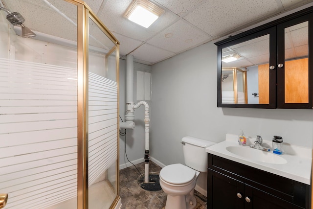 full bath with baseboards, toilet, a stall shower, vanity, and a paneled ceiling