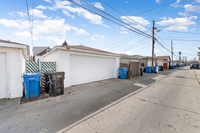 detached garage featuring fence