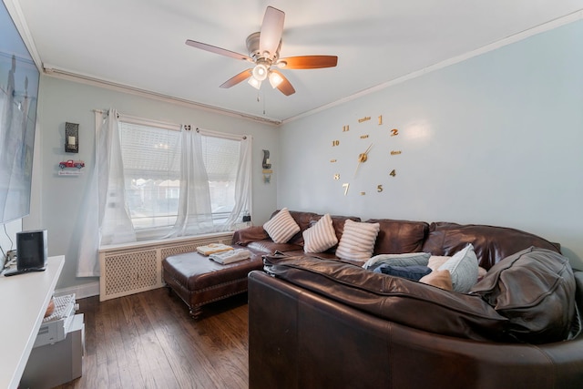 living area featuring a ceiling fan, dark wood-style flooring, and crown molding