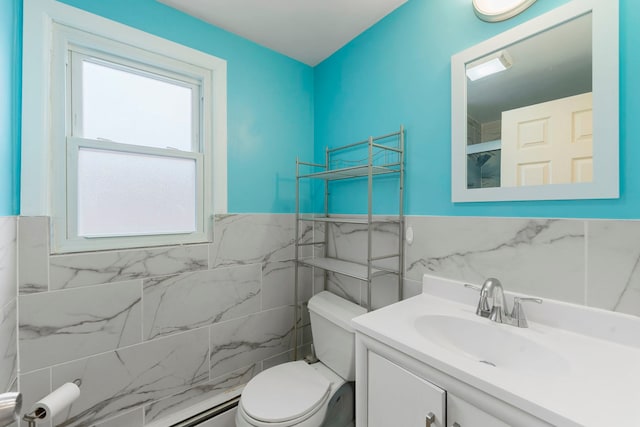 bathroom with vanity, tile walls, toilet, and wainscoting