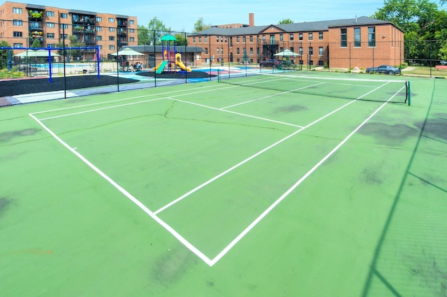 view of sport court with fence and playground community