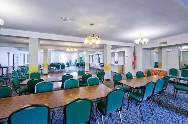 dining area with visible vents and an inviting chandelier