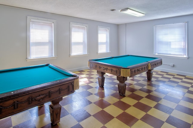 recreation room with billiards, tile patterned floors, and a textured ceiling