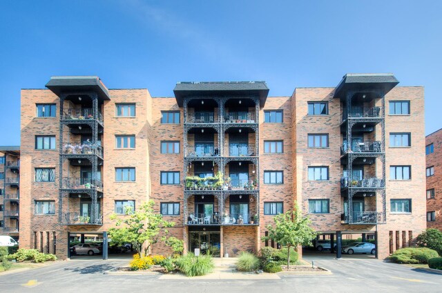 view of building exterior featuring covered parking