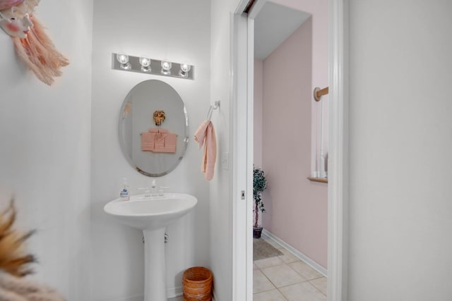 bathroom featuring baseboards and tile patterned flooring