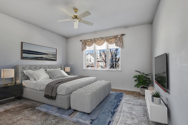 bedroom featuring baseboards, a ceiling fan, and carpet