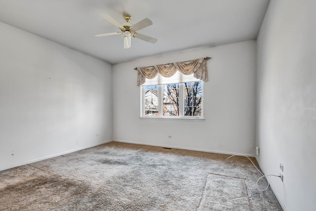 empty room with a ceiling fan, baseboards, and carpet floors