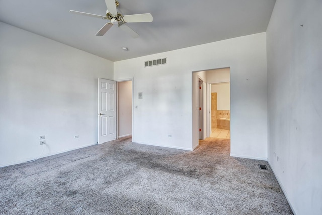 unfurnished bedroom featuring ensuite bath, carpet, visible vents, and baseboards