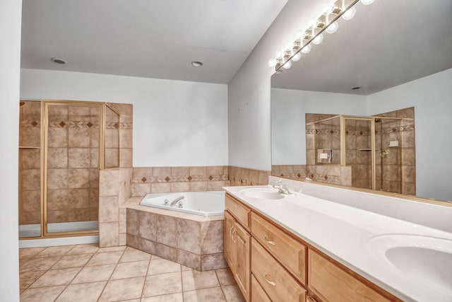 full bathroom featuring tile patterned floors, a bath, a shower stall, and a sink