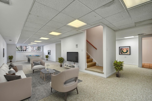 living area with stairway, carpet flooring, a paneled ceiling, and visible vents