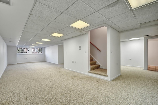 below grade area featuring stairs, visible vents, baseboards, and carpet flooring