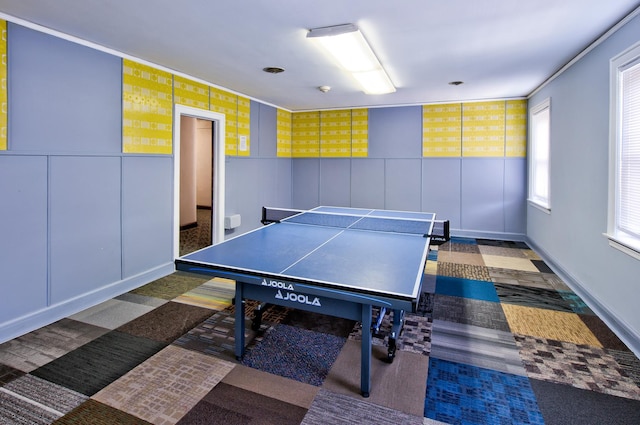 recreation room featuring wainscoting