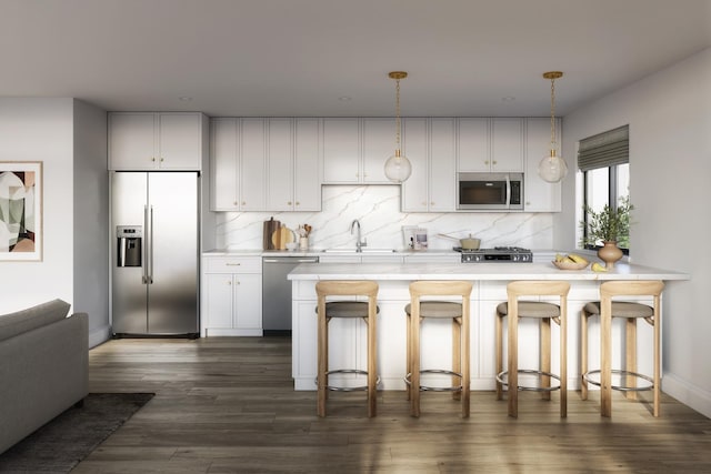 kitchen featuring dark wood finished floors, a sink, decorative backsplash, light countertops, and appliances with stainless steel finishes