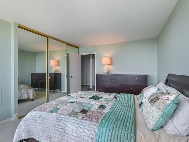 bedroom featuring a closet, baseboards, and carpet floors