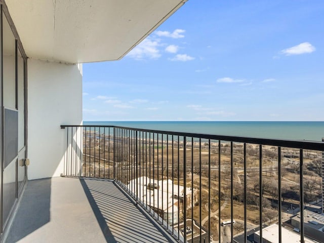 balcony with a water view and a beach view