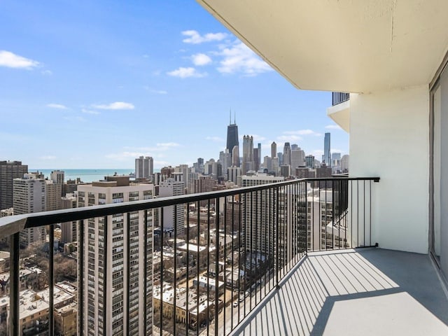 balcony featuring a view of city and a water view