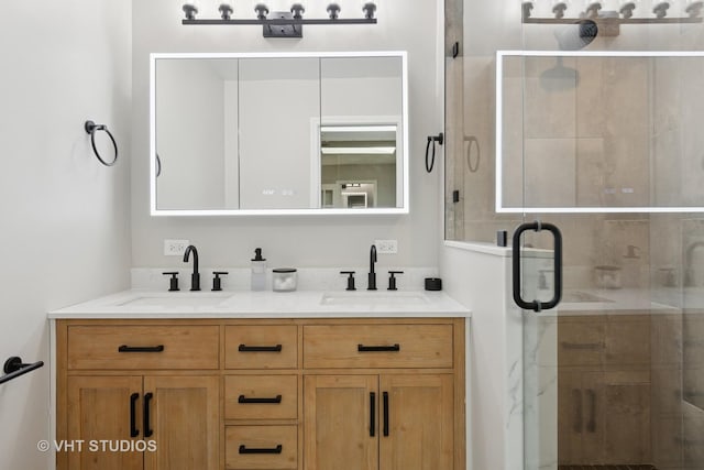 bathroom featuring double vanity, a shower stall, and a sink